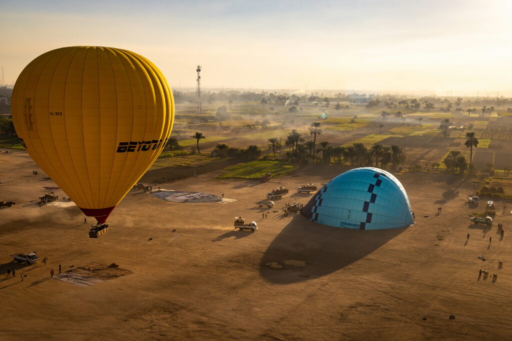 Inflated and deflated hot air balloons in Luxor signifying the completion of the journey with ascent and descent.